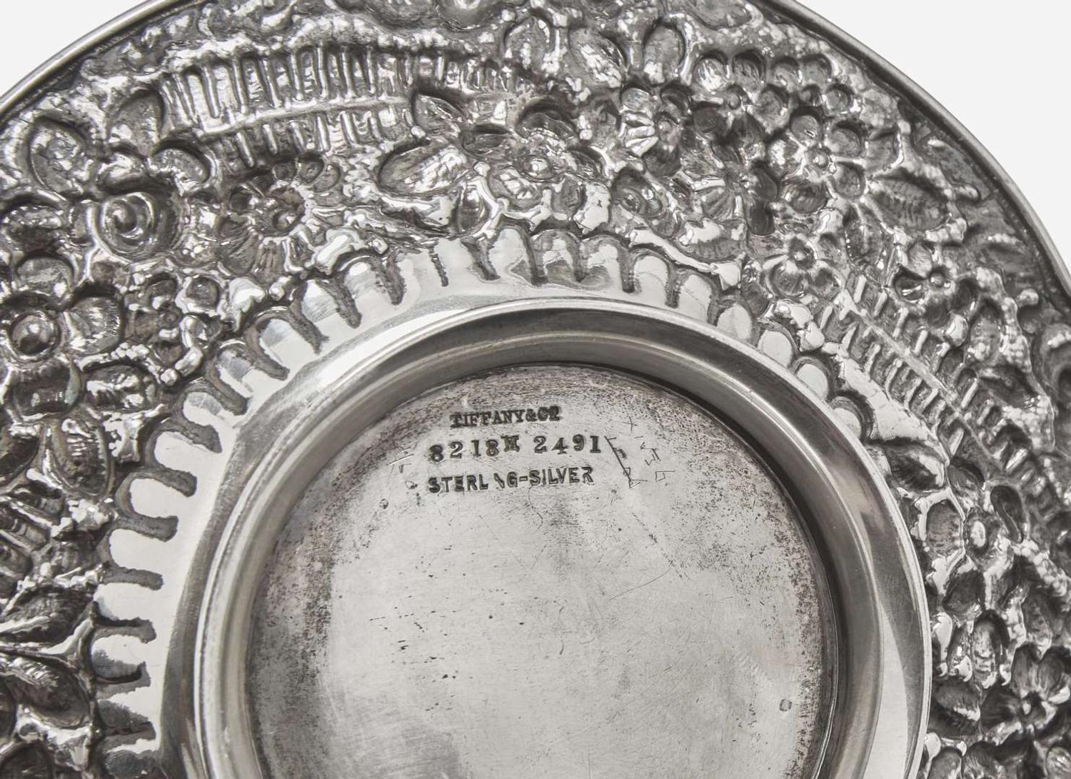 An assembled group of eight sterling silver floral cast and repoussé items, Tiffany & Co., New York, NY, dates ranging 1873-1902