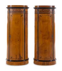 A Pair of Biedermeier Style Parcel Ebonized Satinwood Pedestal-Form Cabinets