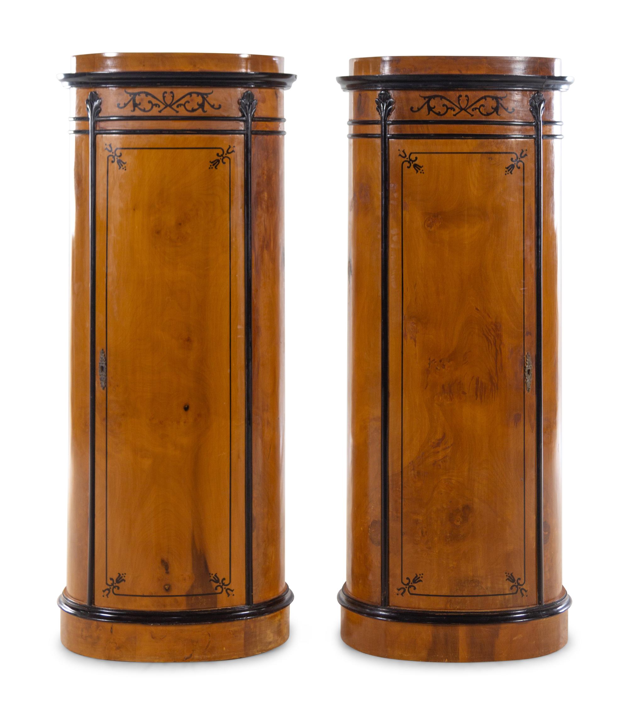 A Pair of Biedermeier Style Parcel Ebonized Satinwood Pedestal-Form Cabinets