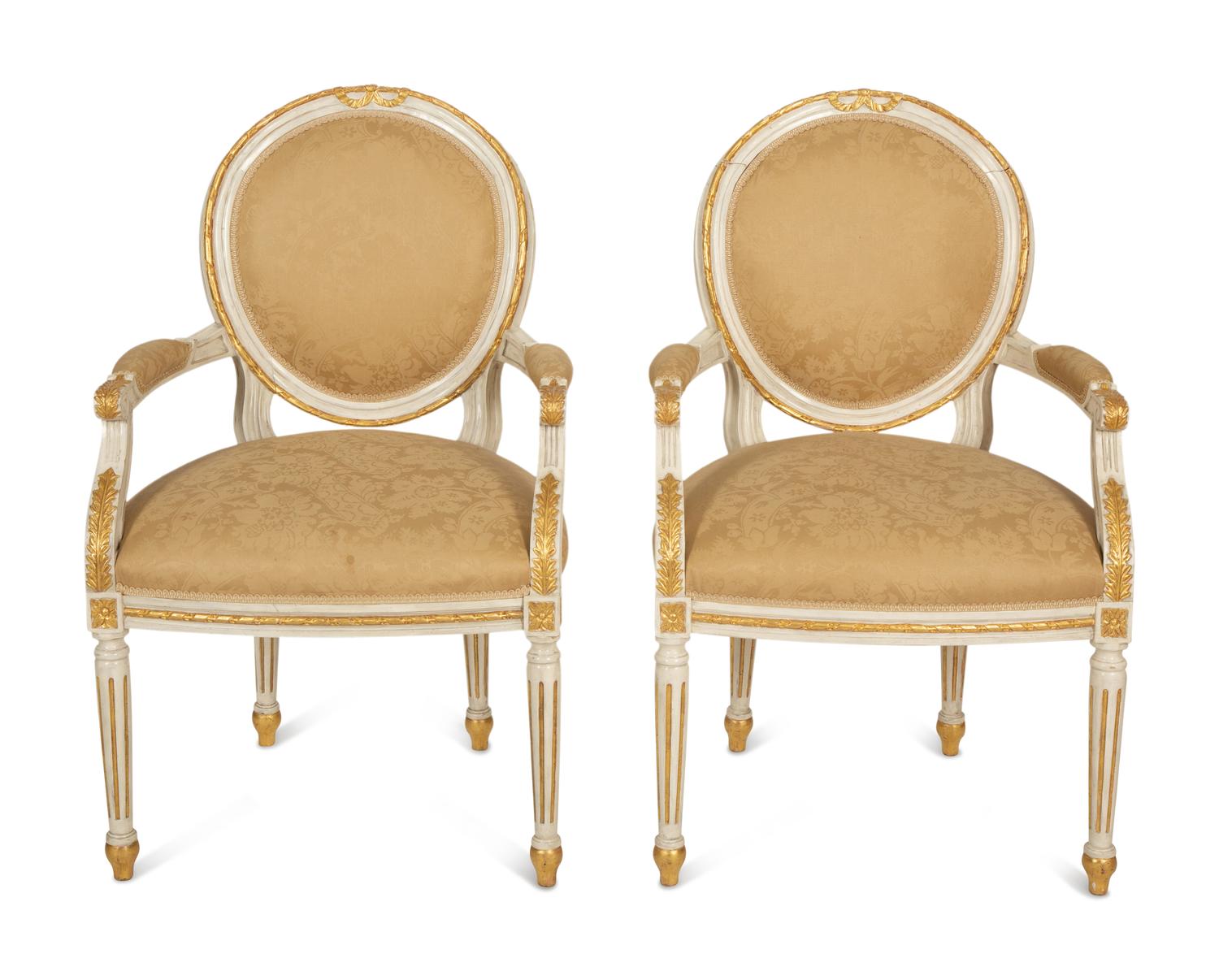 A Set of Eight Louis XVI Style Painted and Parcel Gilt Fauteuils