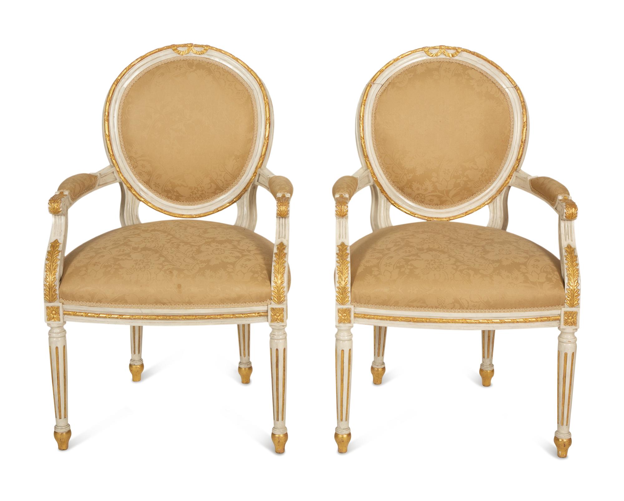 A Set of Eight Louis XVI Style Painted and Parcel Gilt Fauteuils