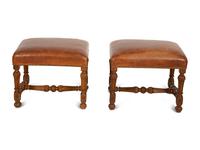 A Pair of Carved Walnut Regence Style Leather Upholstered Stools