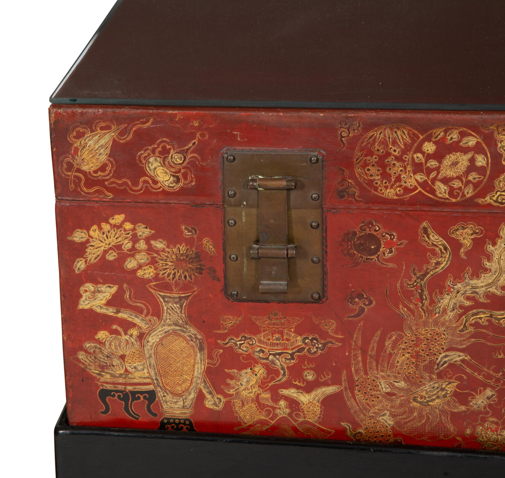 A Chinese Gilt-Decorated Red Leather Trunk on Black Lacquered Stand
