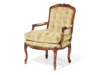 A Louis XV Style Carved Fruitwood Fauteuil