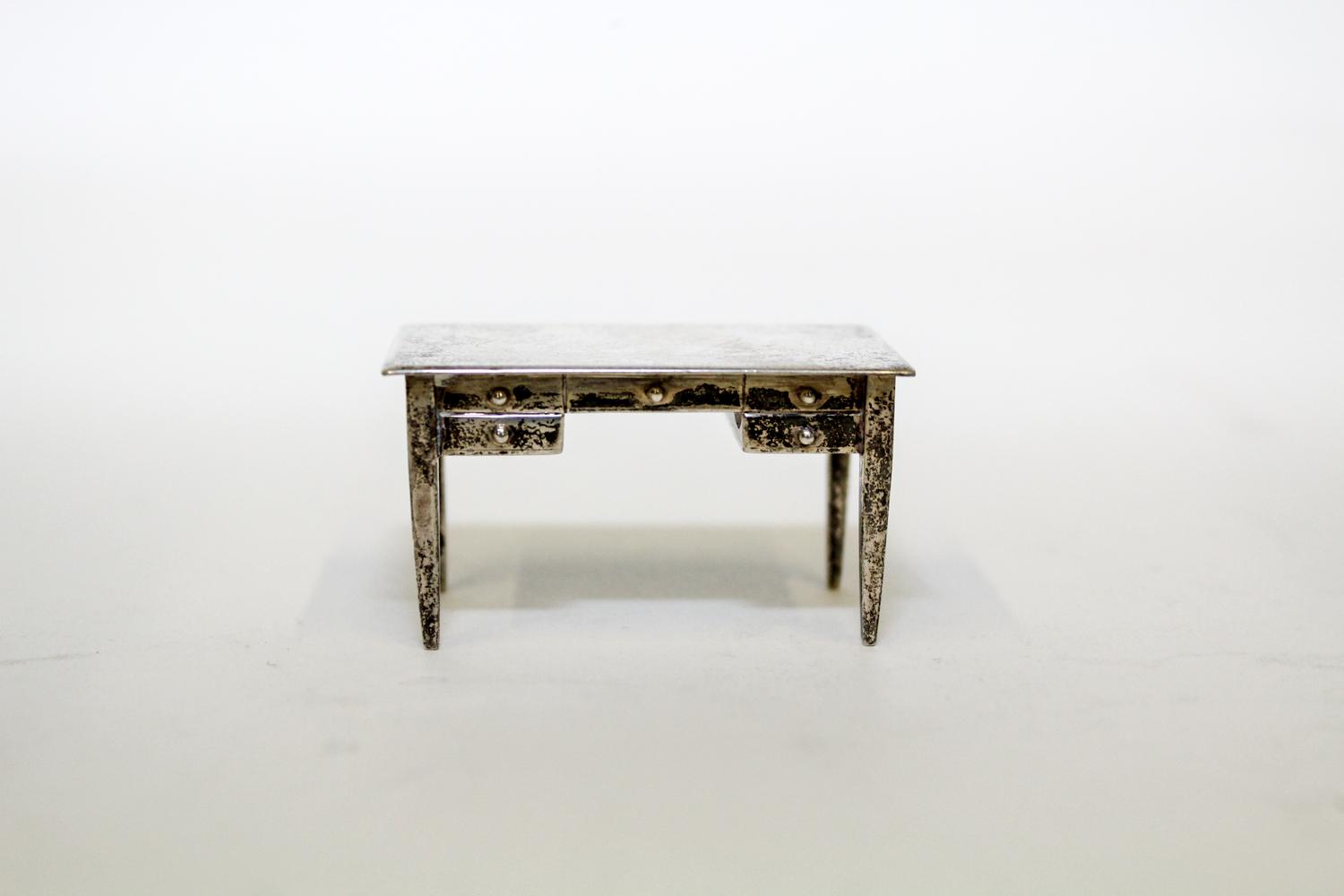 An American Silver Miniature Desk, International Silver Co., Meriden, CT, having a rectangular top over one long drawer and flanking sh