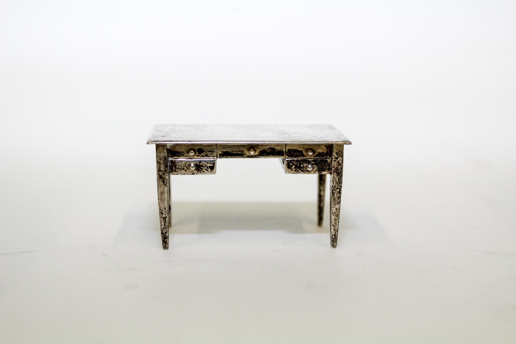 An American Silver Miniature Desk, International Silver Co., Meriden, CT, having a rectangular top over one long drawer and flanking sh