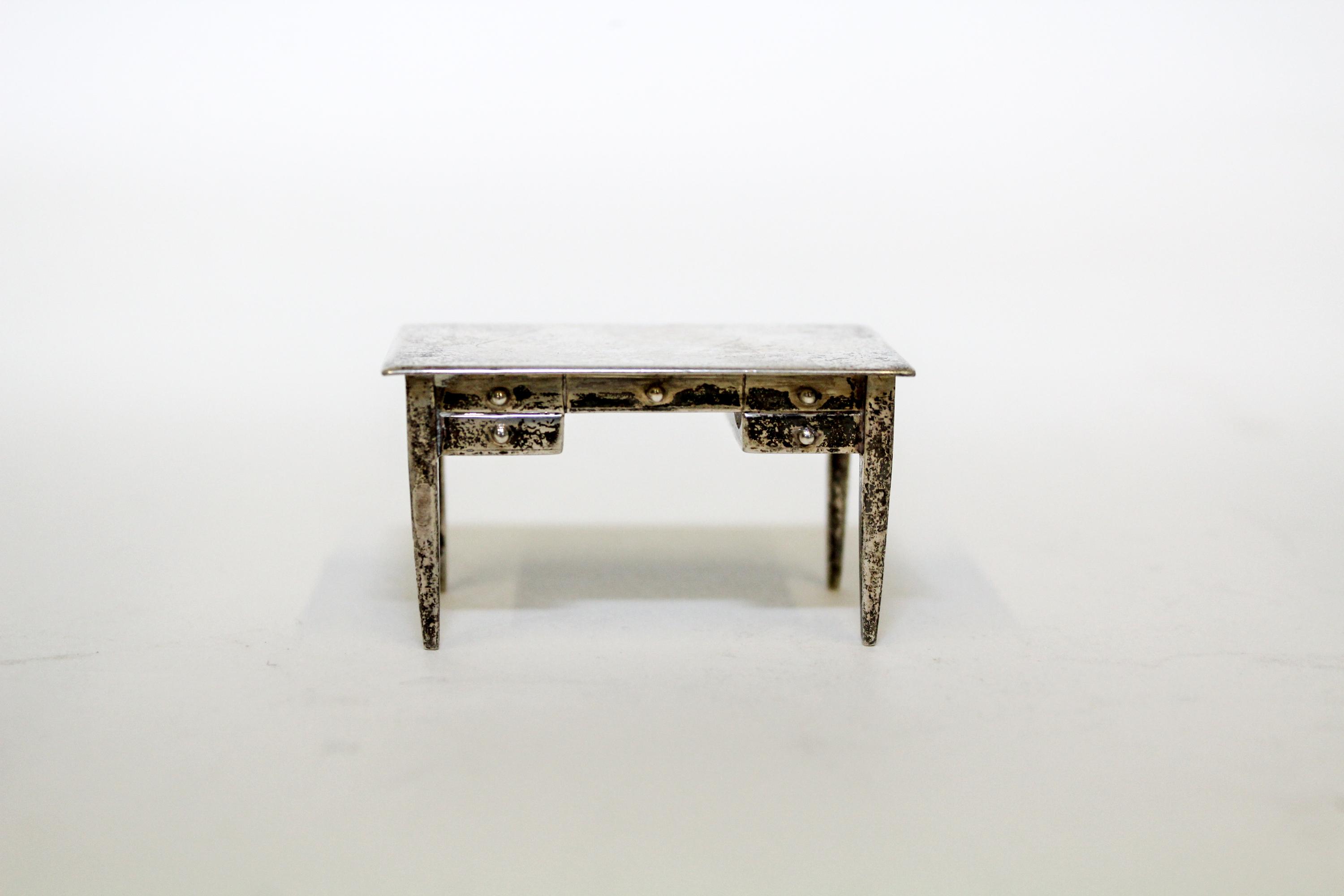 An American Silver Miniature Desk, International Silver Co., Meriden, CT, having a rectangular top over one long drawer and flanking sh