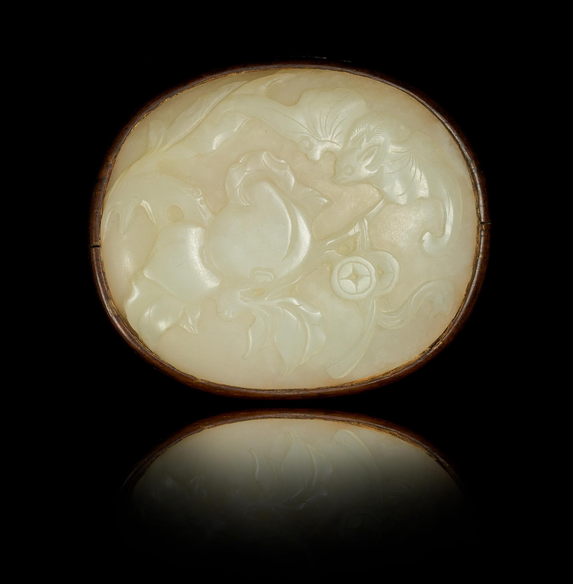 A White Jade Oval Plaque Length 3 inches. — 19TH CENTURY