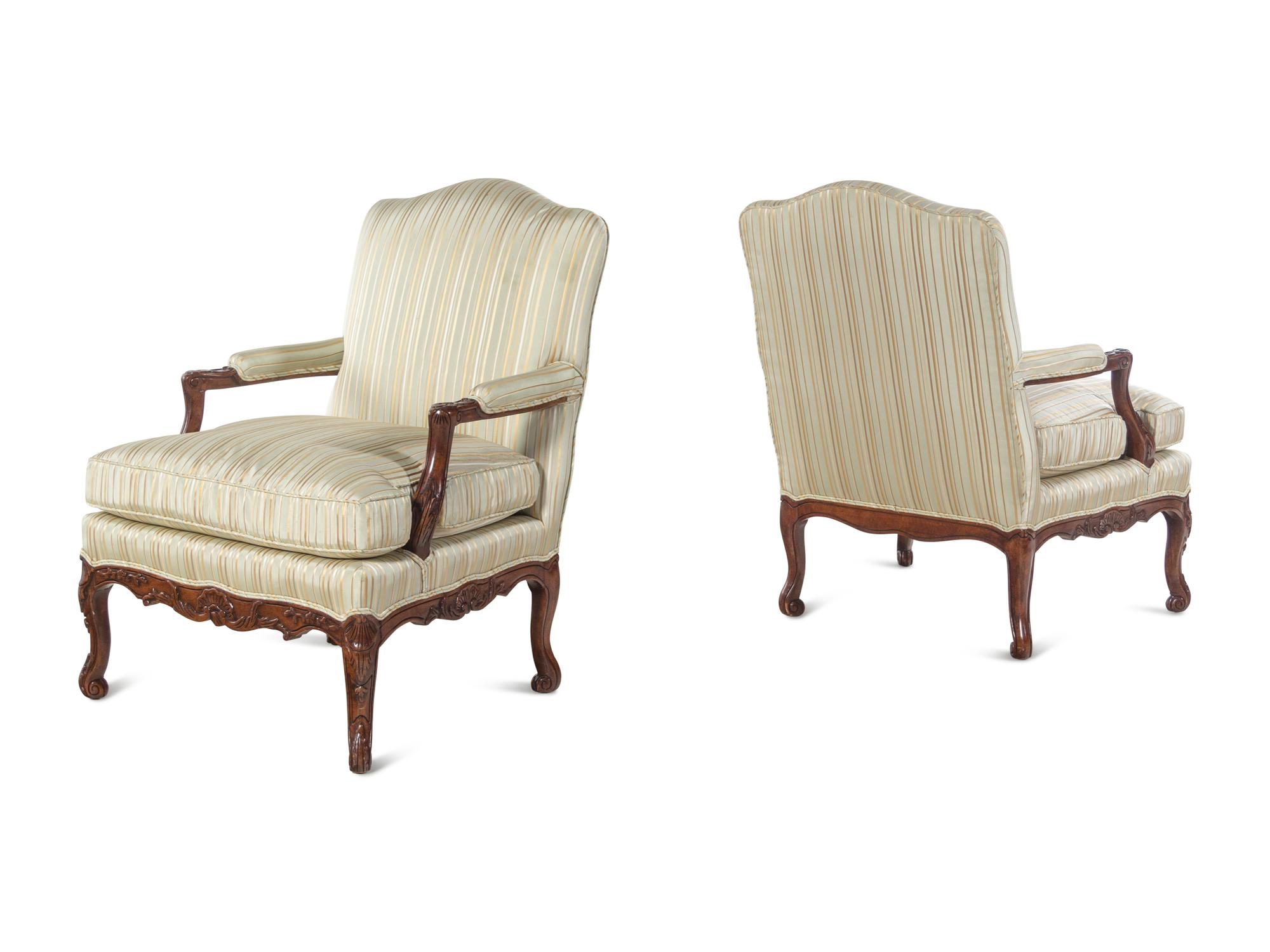 A Pair of Louis XV Style Carved Walnut Fauteuils