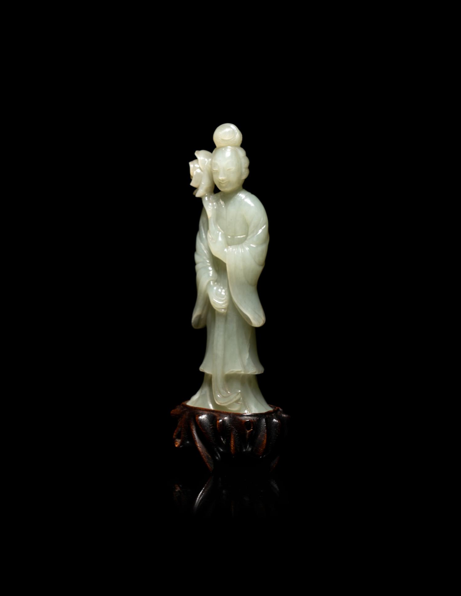 A Chinese Carved Pale Celadon Jade Standing Female Figure