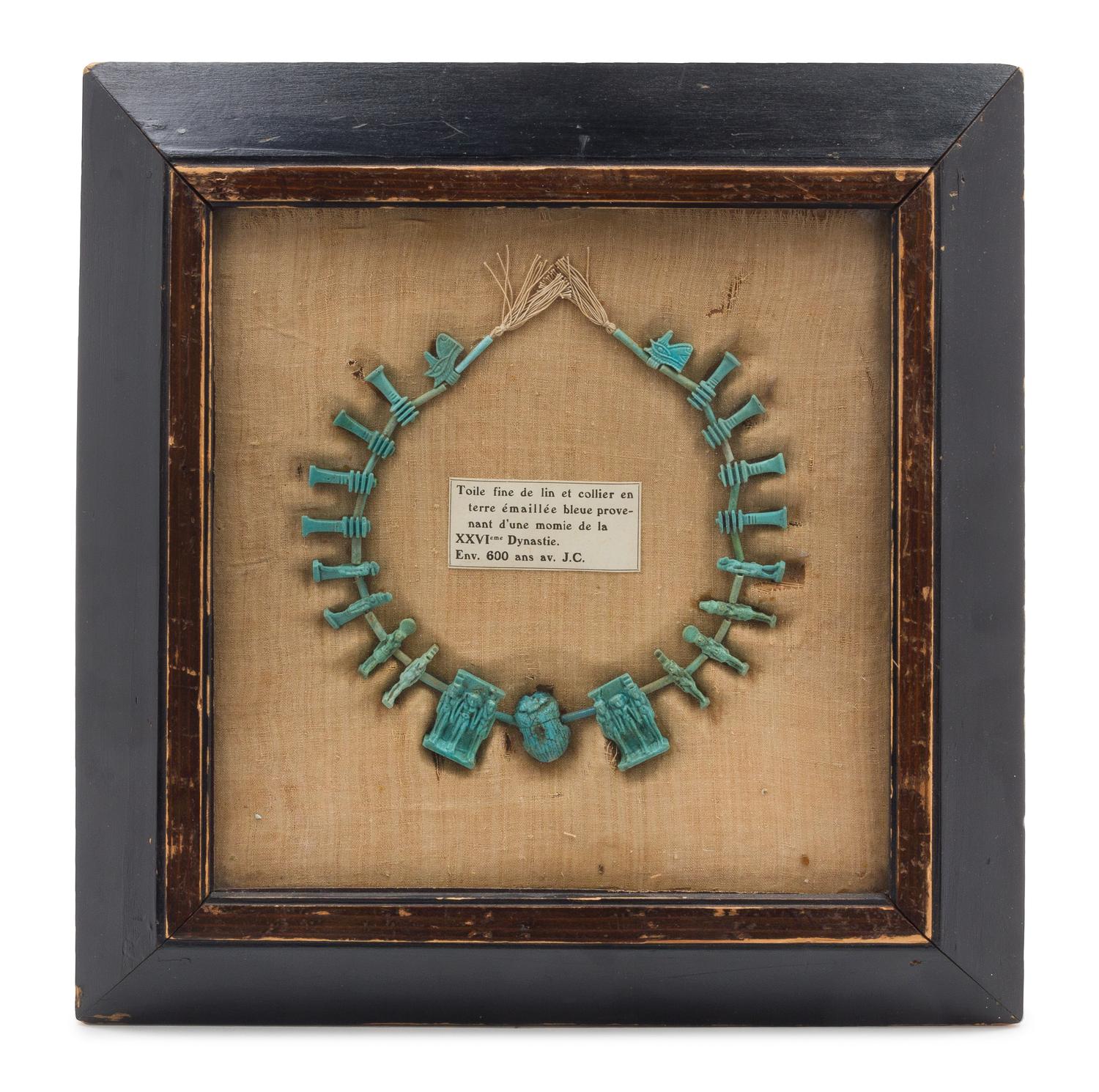 A Framed Egyptian Faience Bead Necklace Width overall 12 1/2 inches. — SAITE PERIOD, 26TH DYNASTY, CIRCA 600 B.C.E.