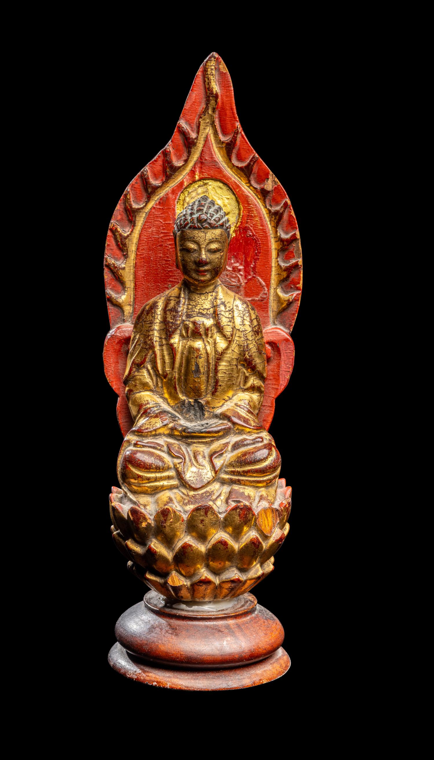 A Gilt and Red Lacquered Wood Figure of Buddha