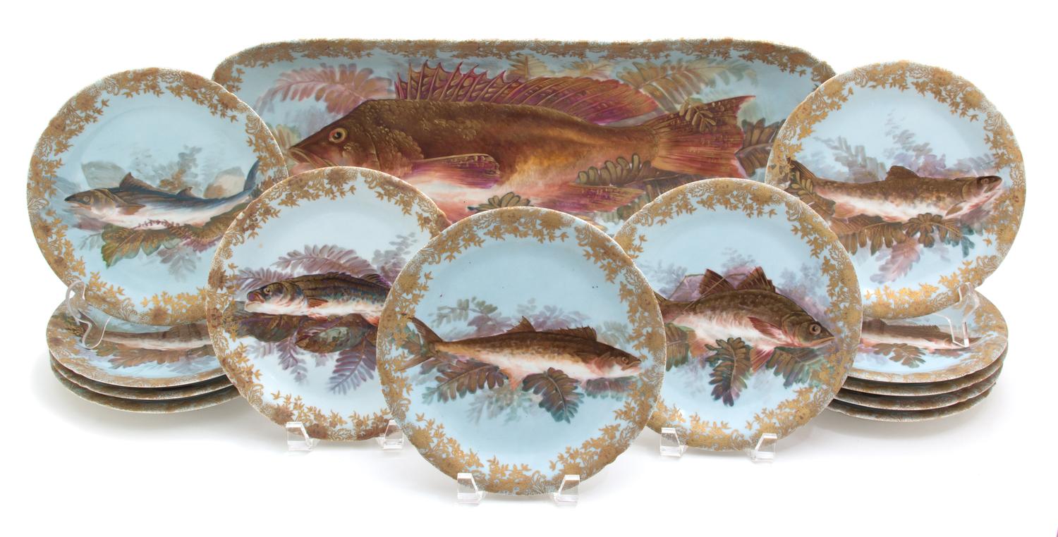 A Thirteen Piece Limoges Porcelain Fish Service EARLY 20TH CENTURY comprising twelve plates and... — EARLY 20TH CENTURY