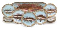 A Thirteen Piece Limoges Porcelain Fish Service EARLY 20TH CENTURY comprising twelve plates and... — EARLY 20TH CENTURY