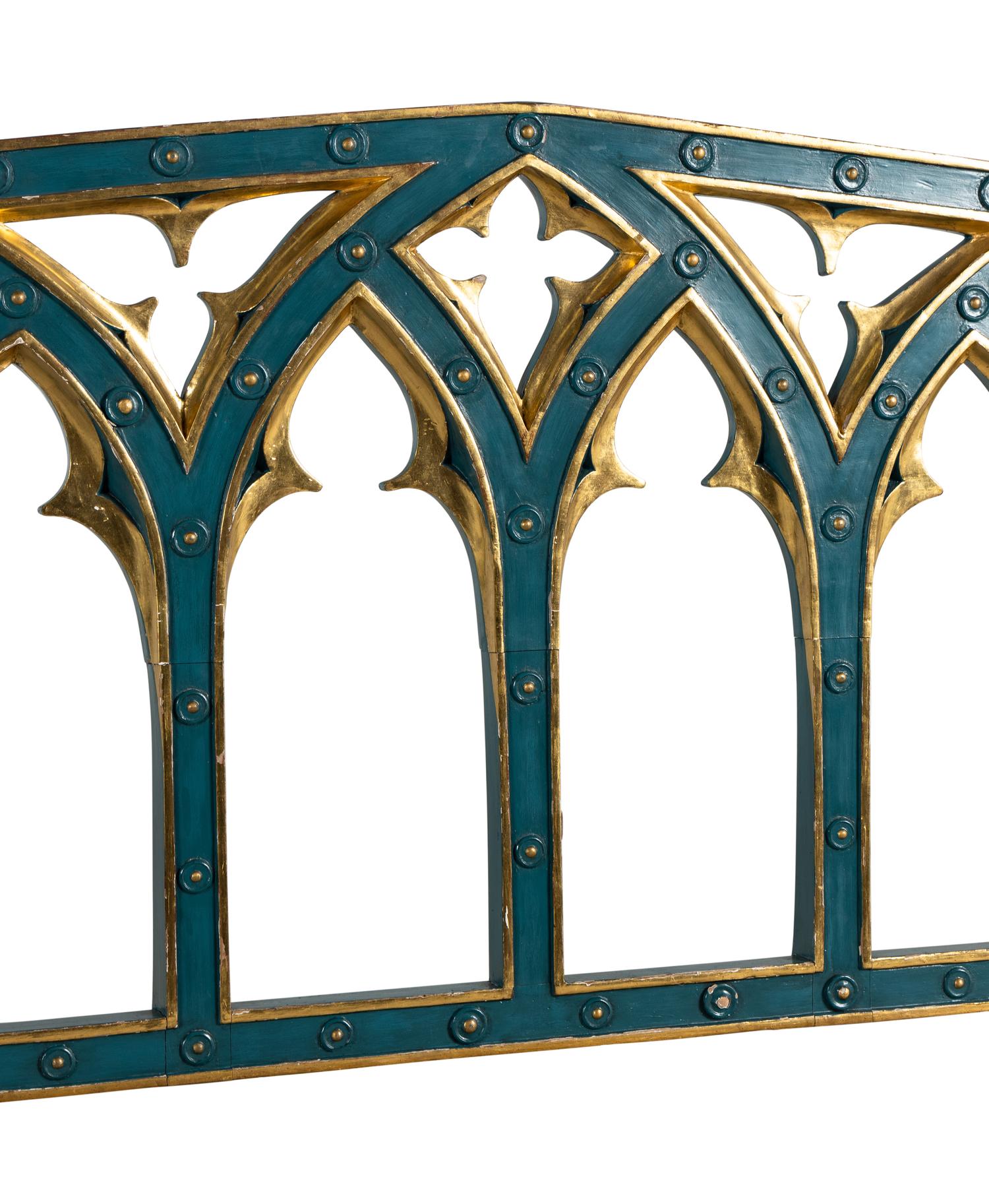 A Pair of English Gothic Revival Painted and Parcel Gilt Settees