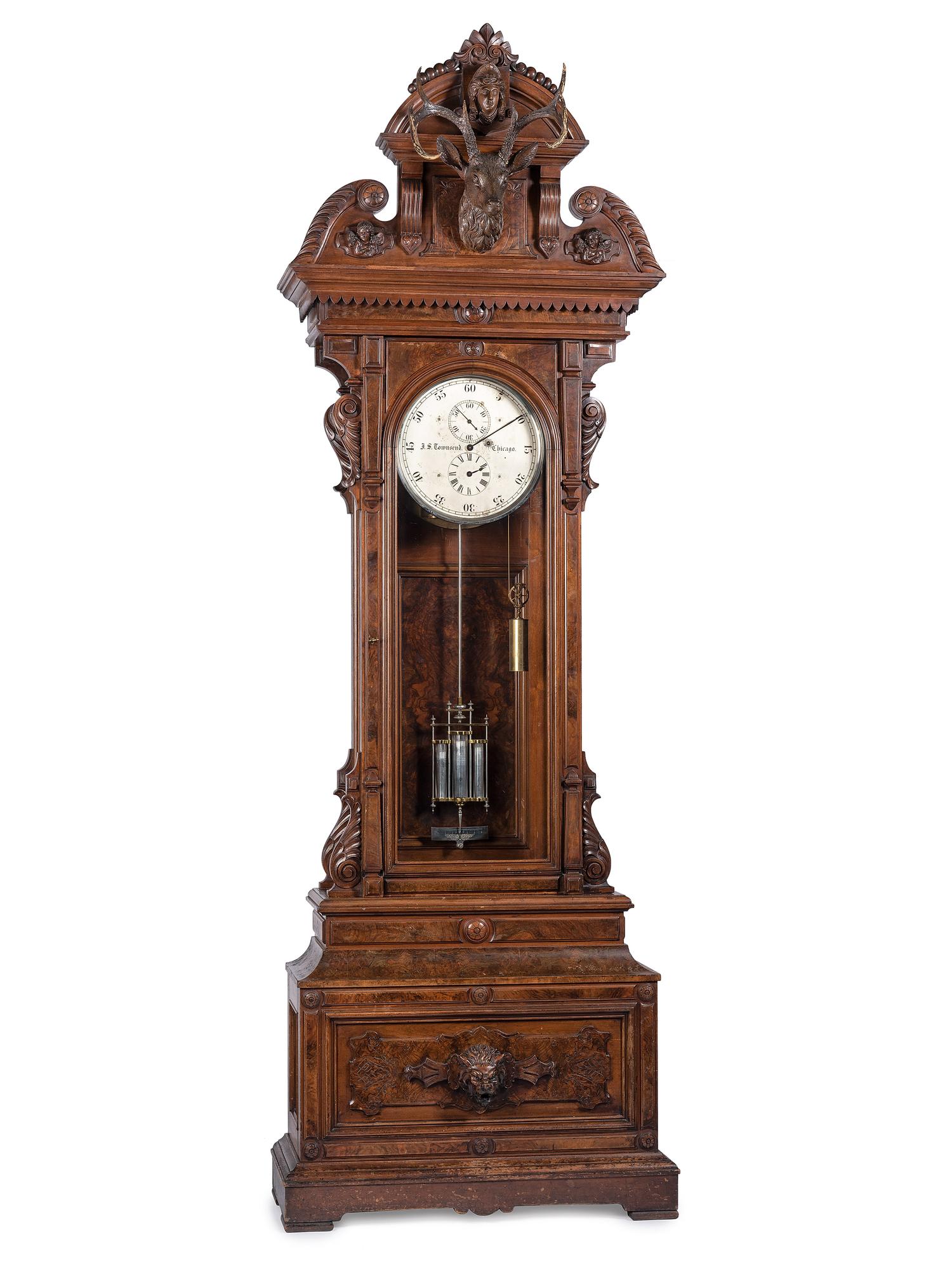 An Impressive Renaissance Revival Carved Walnut Tall Case Regulator Clock