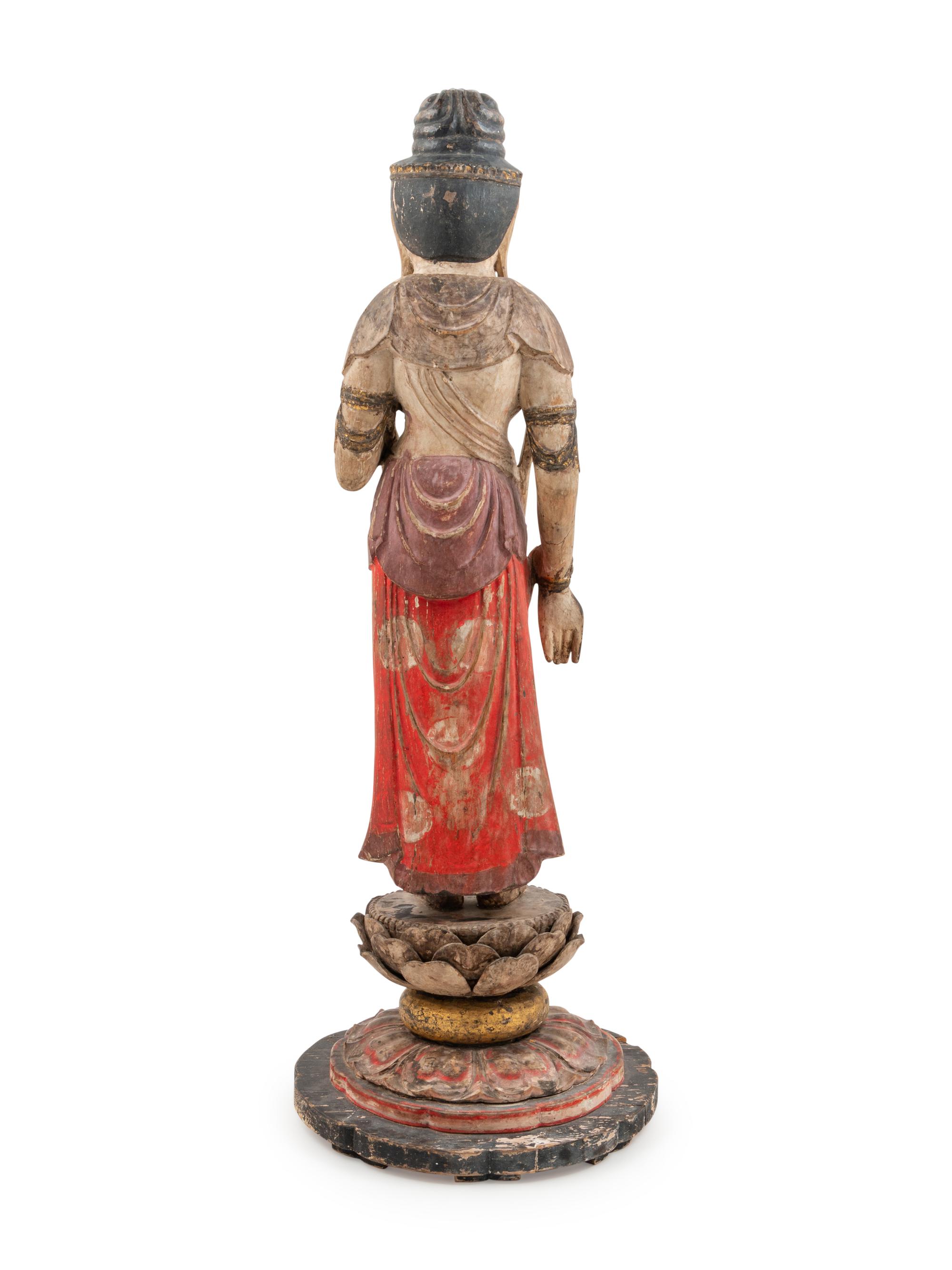 A Carved and Polychrome Lacquered Wood Standing Buddha