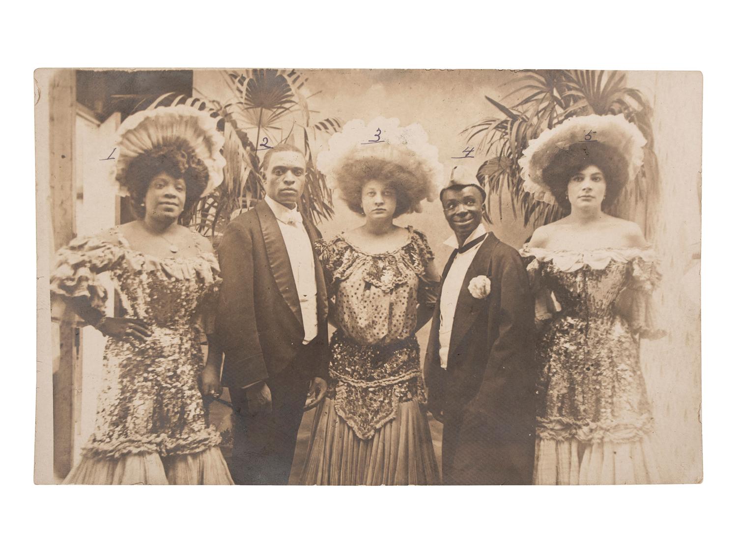 [AFRICAN AMERICANA]--[ENTERTAINMENT]. Real photo postcard of identified Vaudevillle entertainers, incl. interracial couple Sherman and Lulu Coates. 28 July 1906.