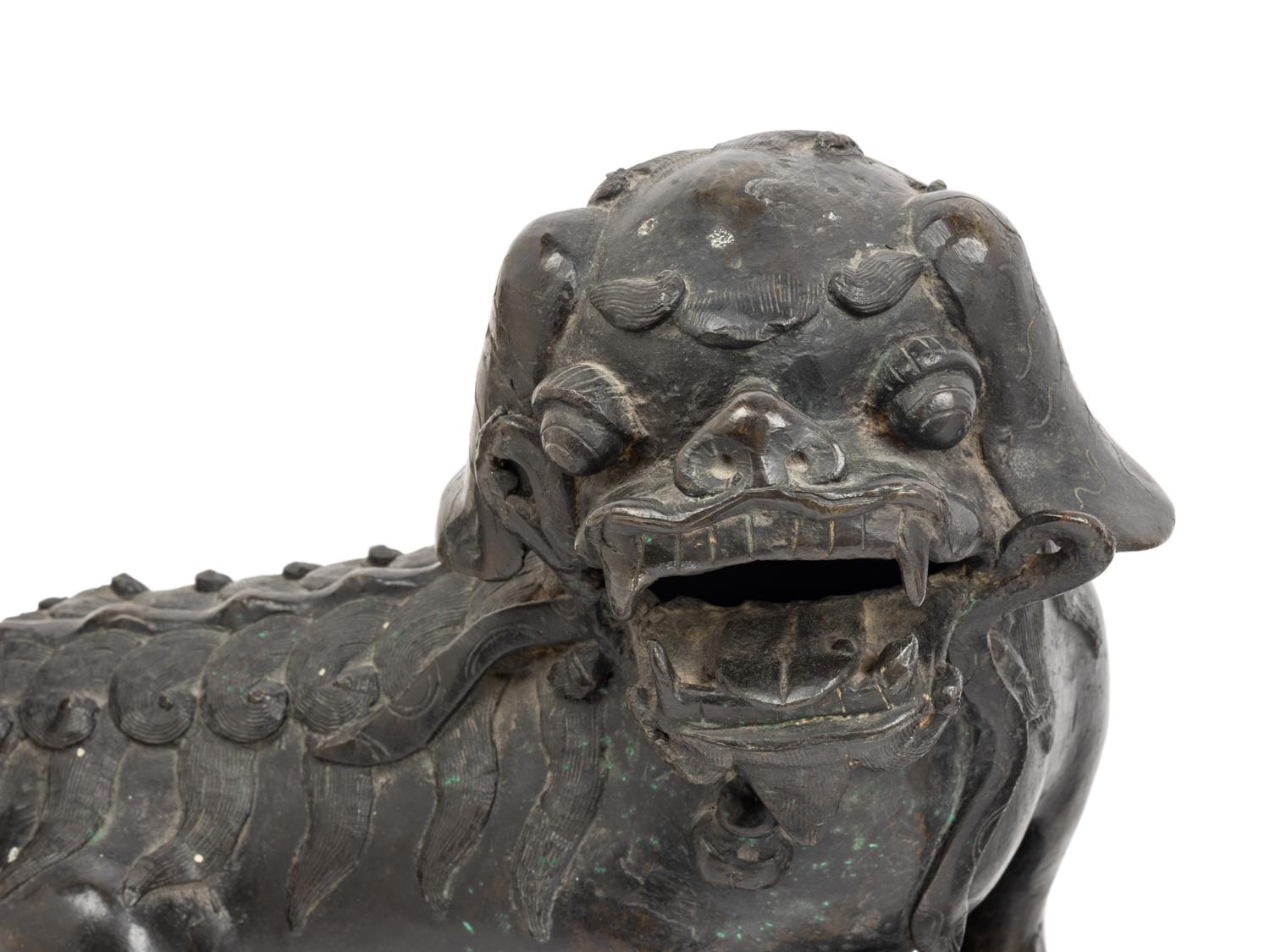 A Pair of Chinese Bronze Buddhistic Lions with Wood Stands