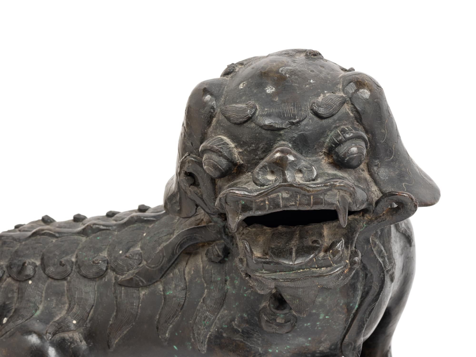 A Pair of Chinese Bronze Buddhistic Lions with Wood Stands