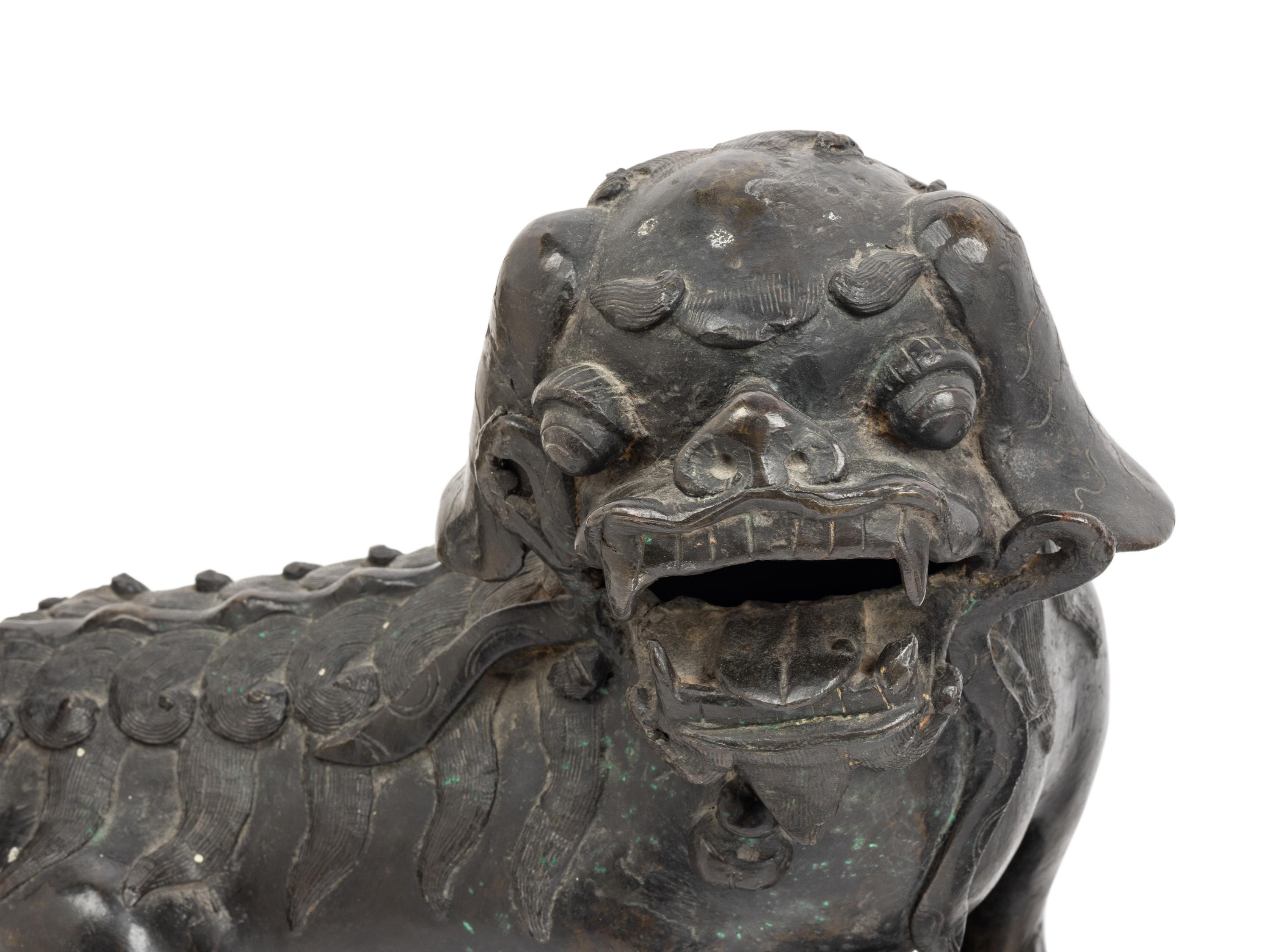 A Pair of Chinese Bronze Buddhistic Lions with Wood Stands