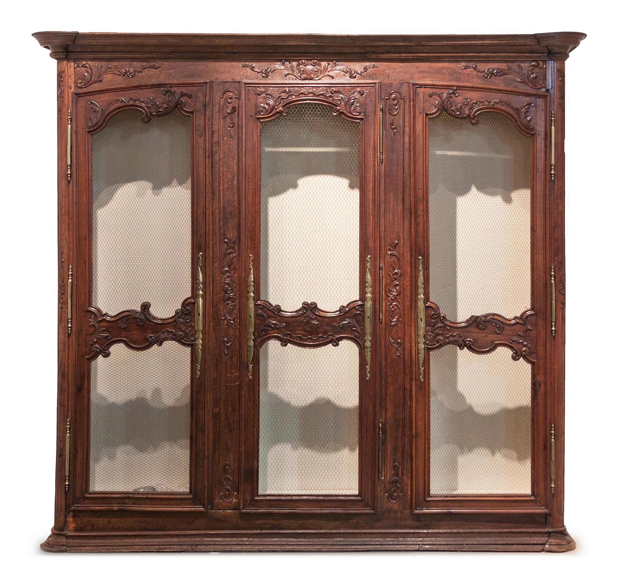 A French Provincial Walnut Bibliotheque, Height 90 x width 87 x depth 15 1/2 inches.