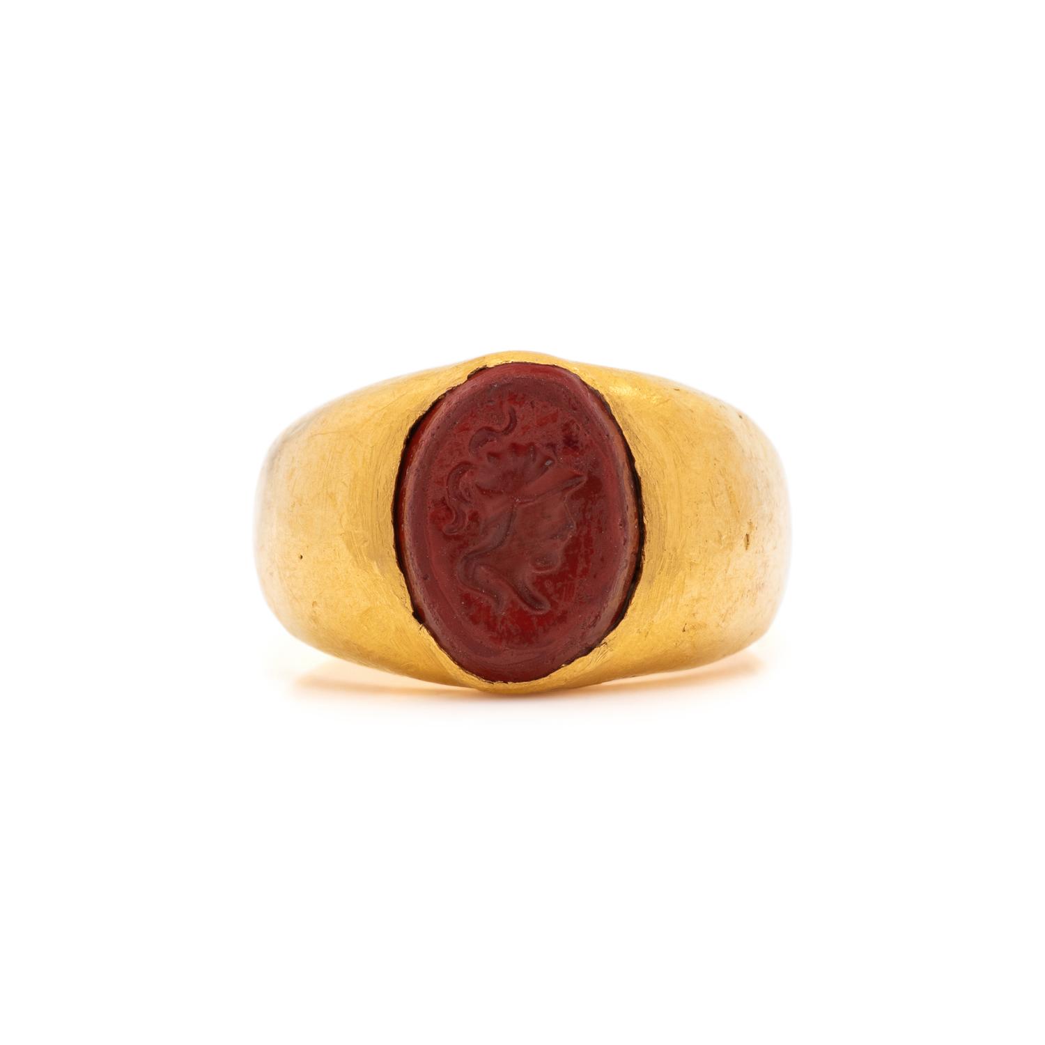 A Roman Gold and Red Jasper Finger Ring with a Male Portrait Head