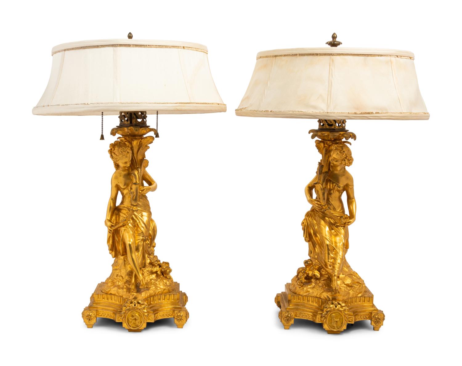 A Pair of French Gilt Bronze Figural Fluid Lamps Converted to Electricity