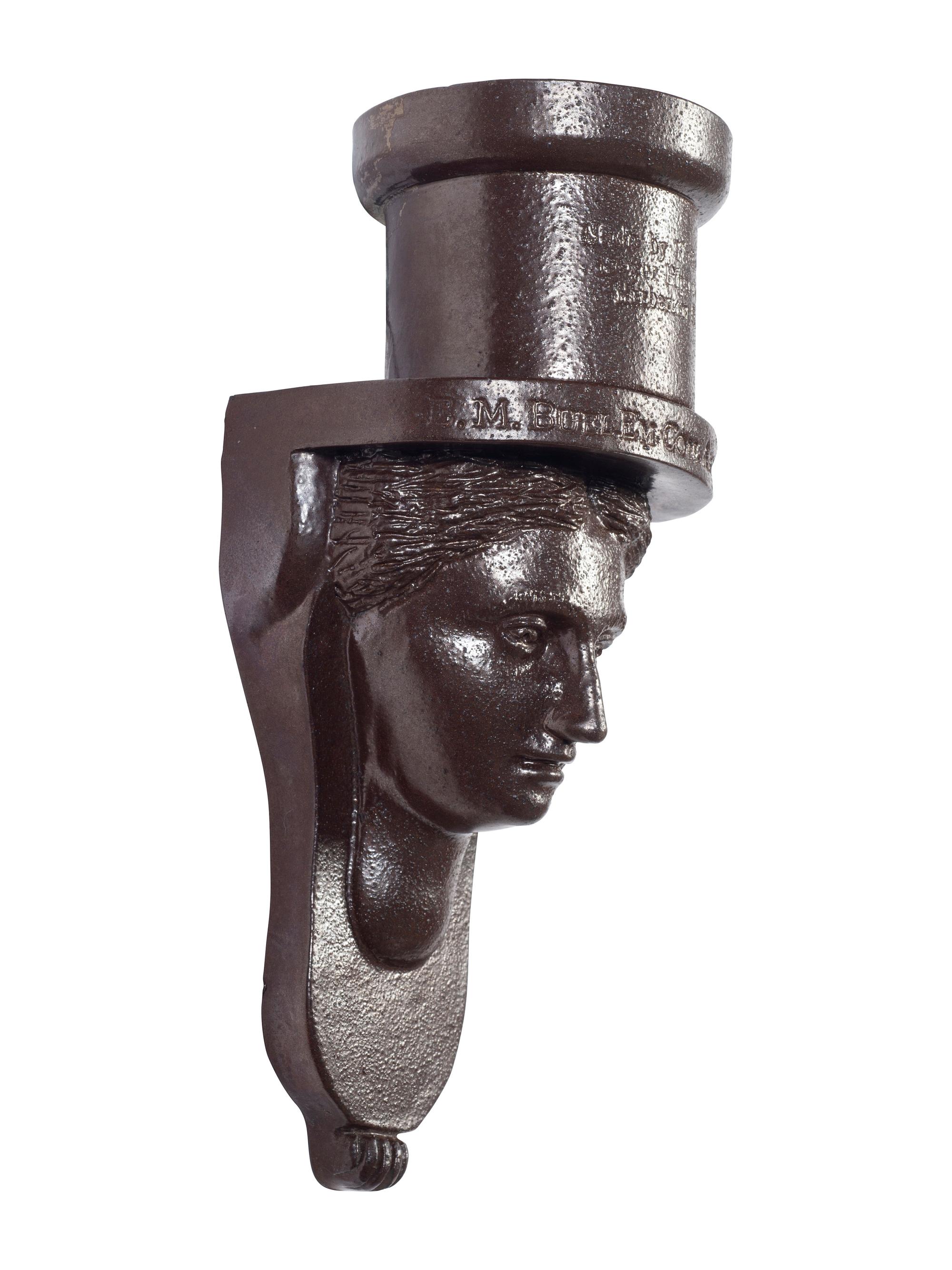 A Glazed Sewer Tile 'Liberty Head' Hanging Match Holder