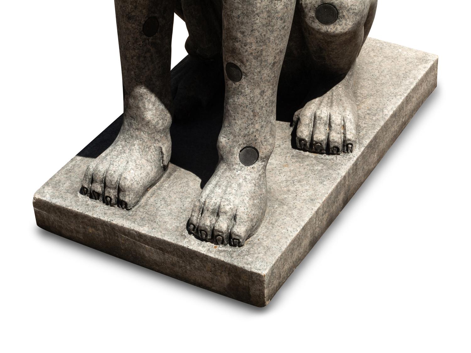 A Pair of Carved Granite and Black Marble Inlaid Seated Dogs