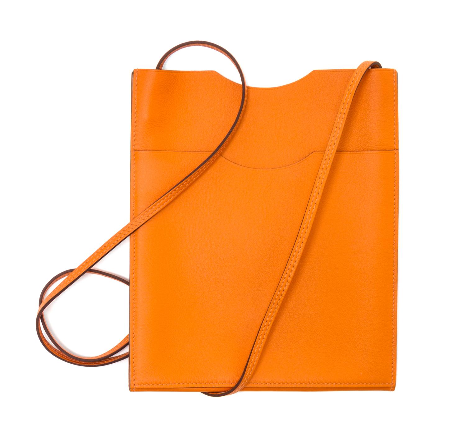 An Hermes Orange Leather Passport Pouch, 7" x 8" x 1".