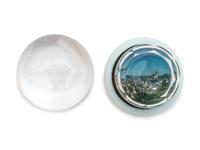 A Village Scene Diorama Faceted Glass Paperweight and a Commemorative Glass Paperweight