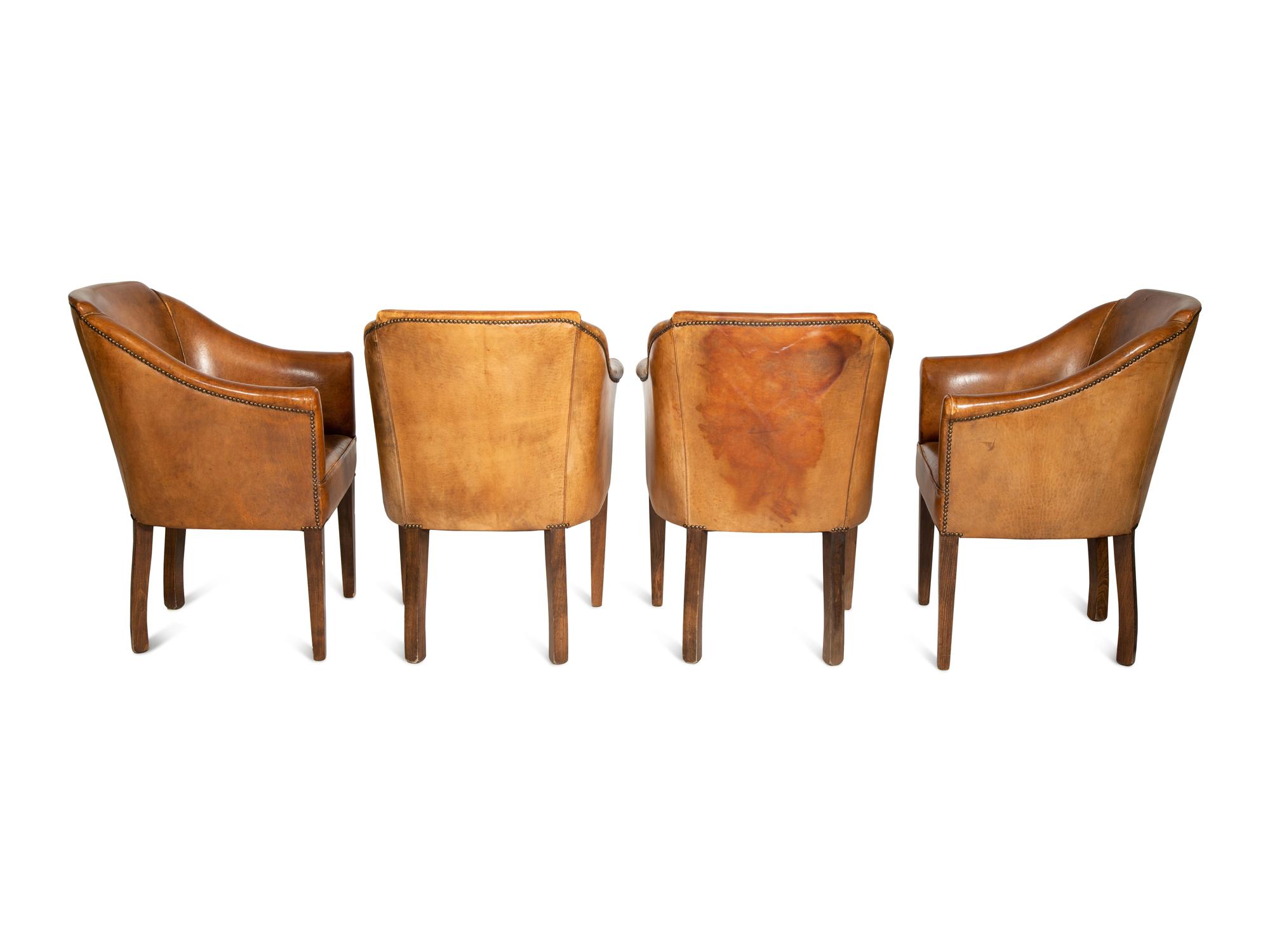 A Set of Four Leather-Upholstered Barrel-Back Armchairs