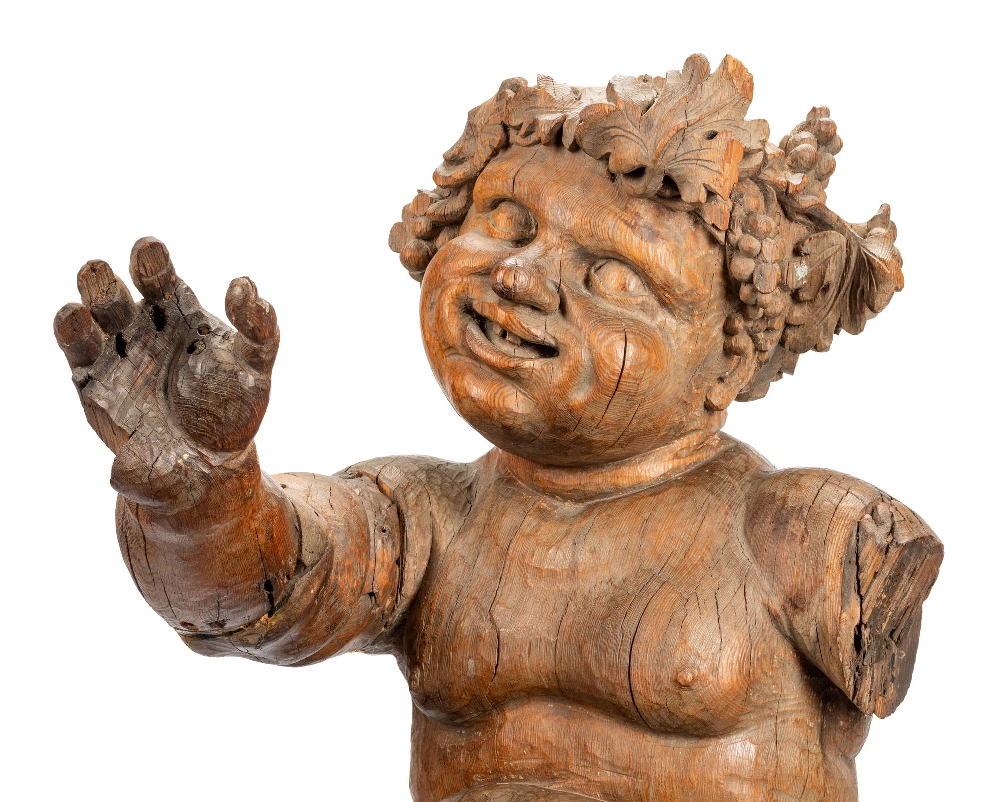 An Italian Carved Wood Figure of Bacchus on a Later Associated Faux Marble Pedestal
