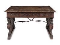 A Renaissance Revival Iron-Mounted Carved Walnut Library Table