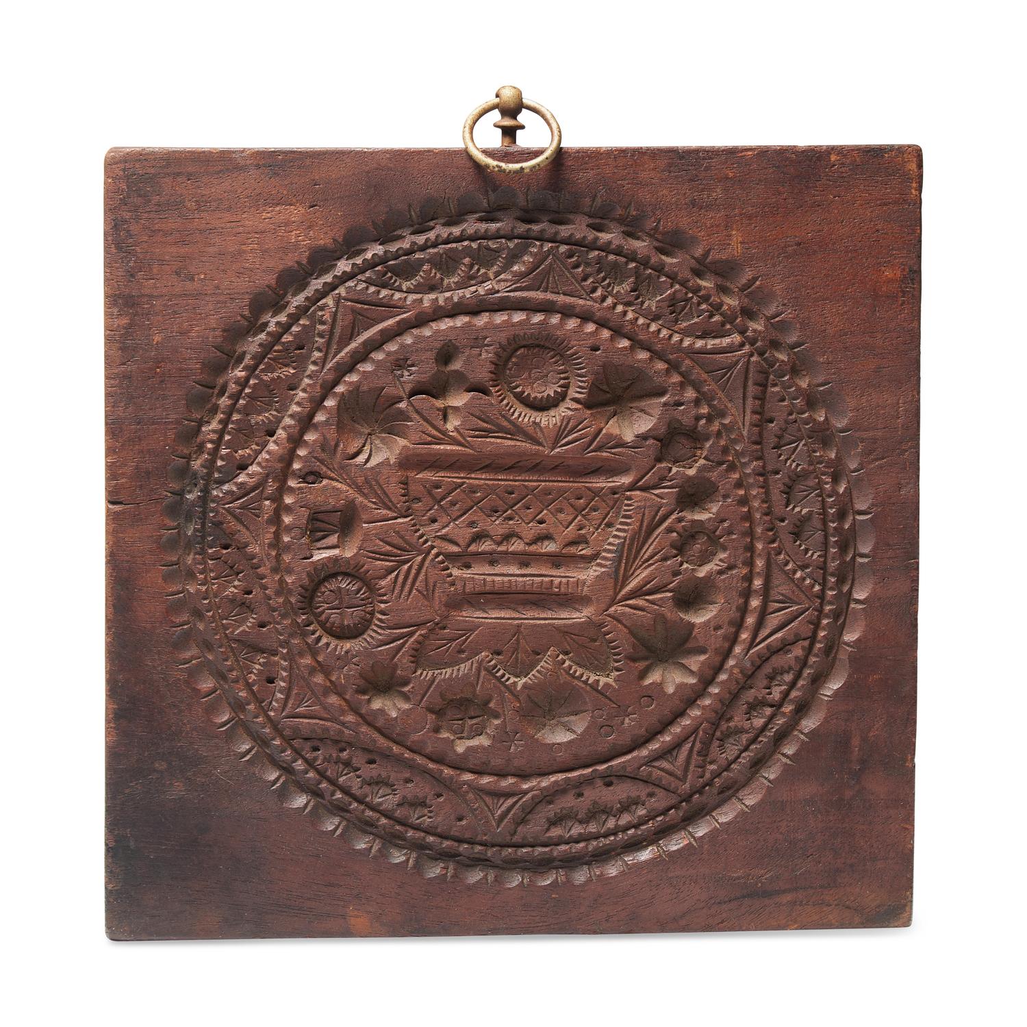 A Carved Walnut Cakeboard