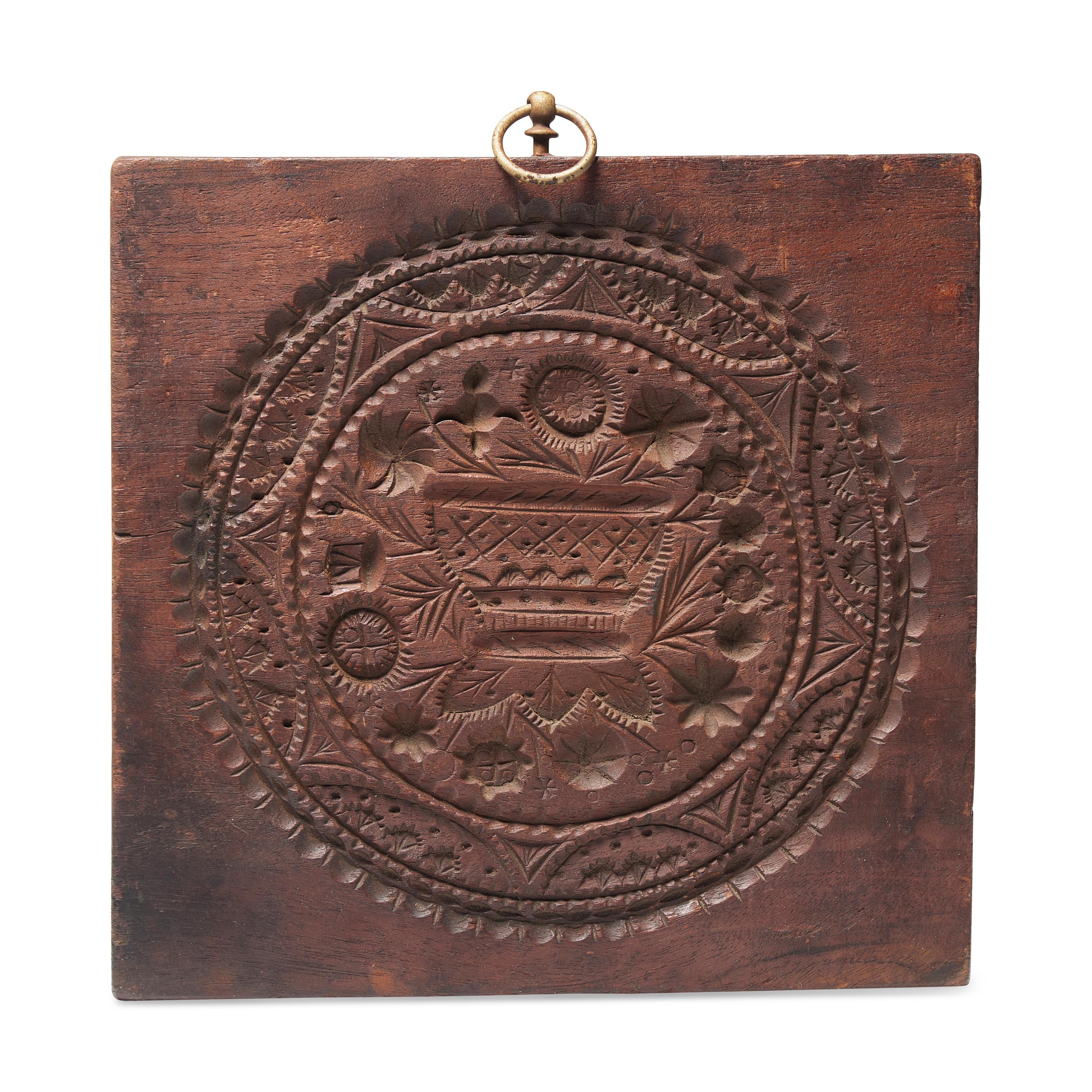 A Carved Walnut Cakeboard