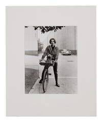 Sid Avery (1918-2002) Audrey Hepburn on her bicycle with her dog "Famous" at Paramount Studios, Los Angeles, CA, 1957