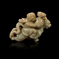 A Chinese greyish white jade carving of a foreigner on a mythical beast 18th Century or earlier