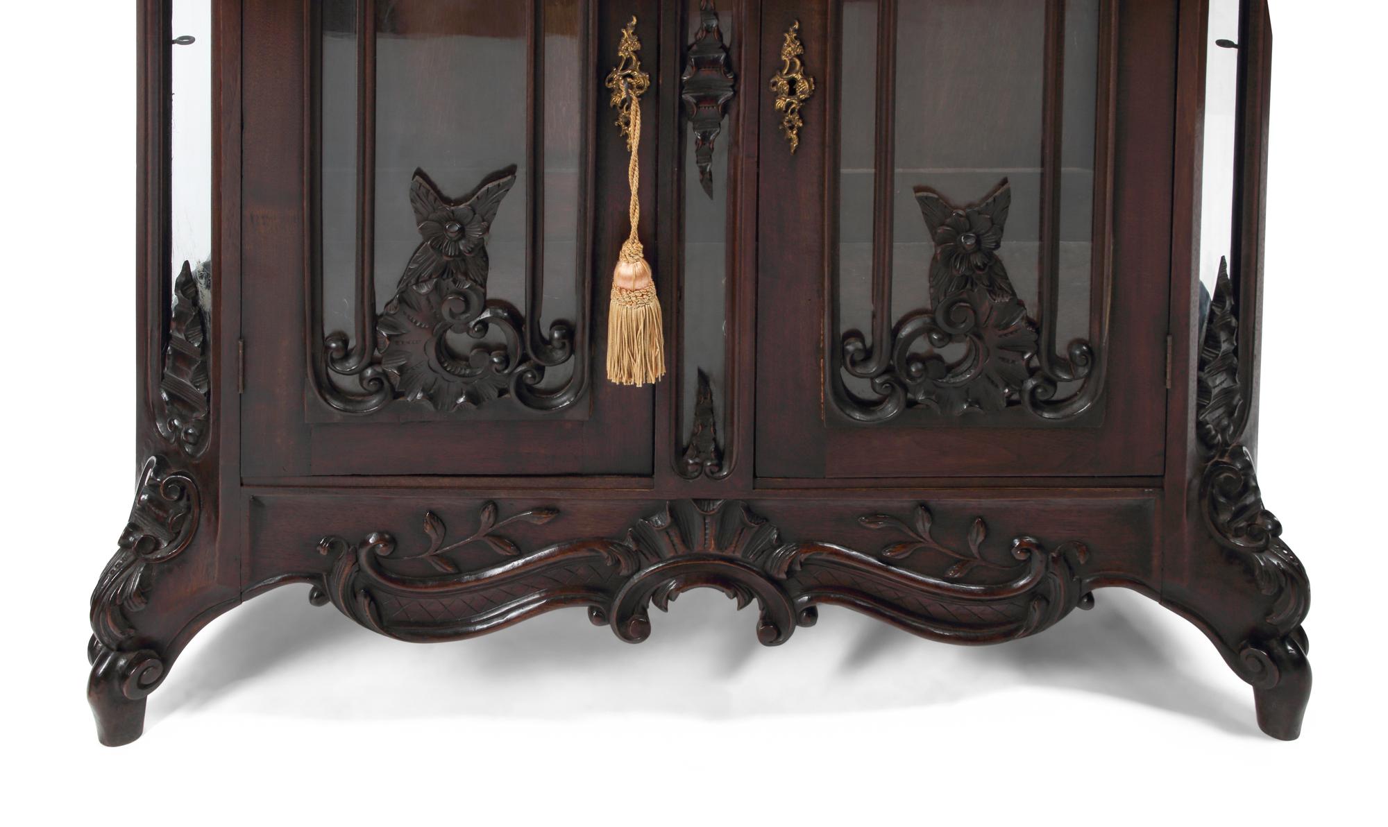 A Pair of Continental Rococo Style Carved Mahogany Vitrine Cabinets