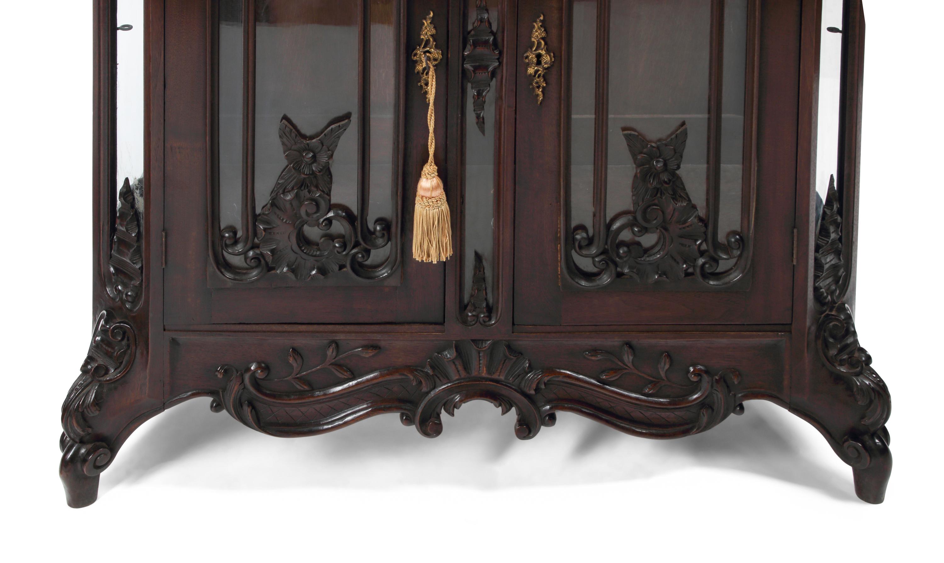 A Pair of Continental Rococo Style Carved Mahogany Vitrine Cabinets