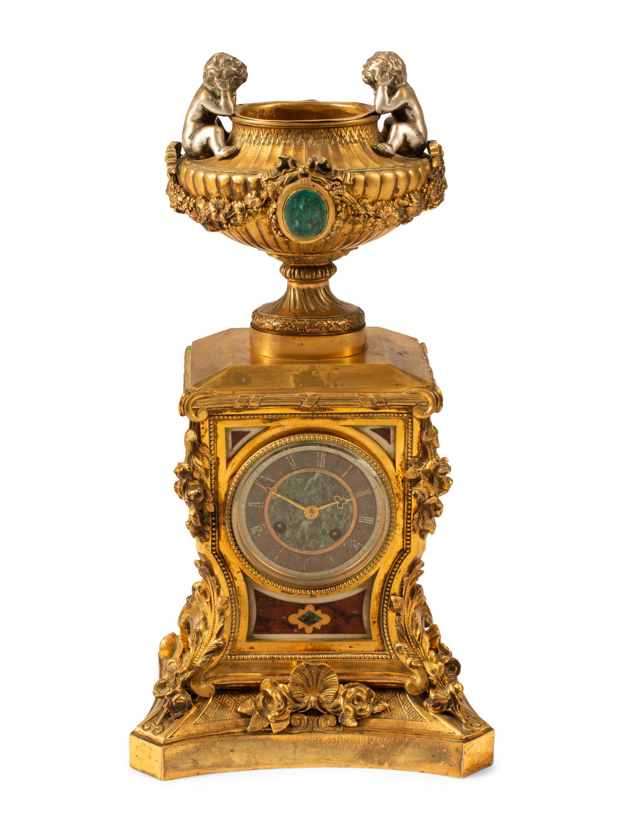 A French Gilt Bronze and Specimen Marble Clock