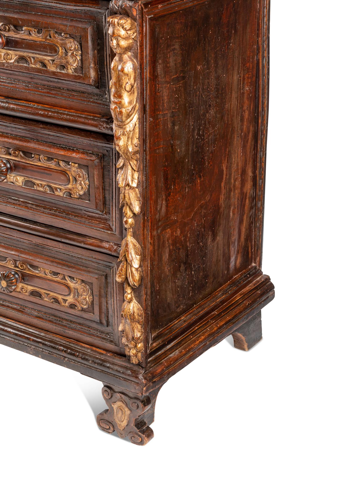 An Italian Baroque Parcel Gilt Walnut Chest of Drawers