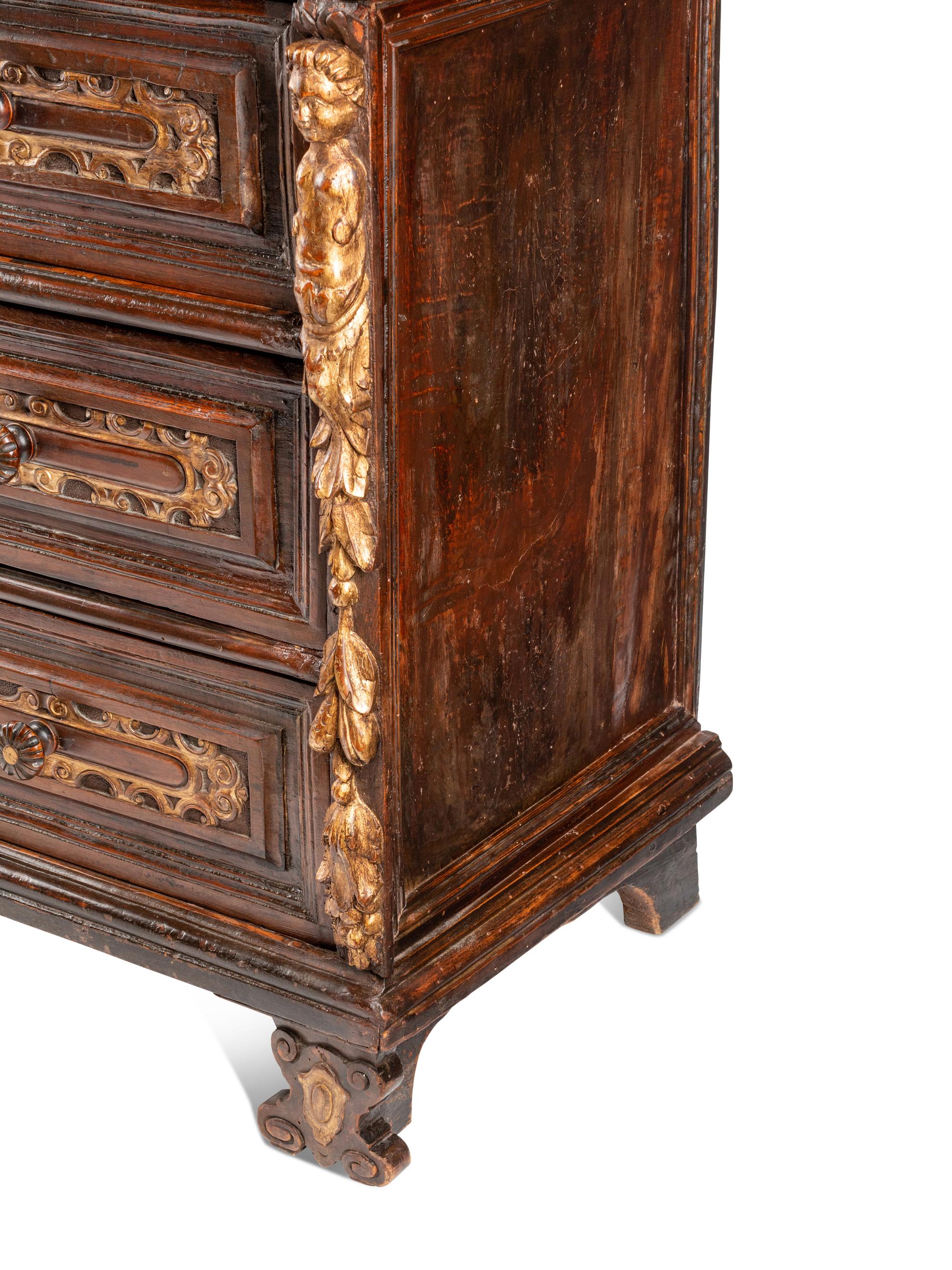An Italian Baroque Parcel Gilt Walnut Chest of Drawers