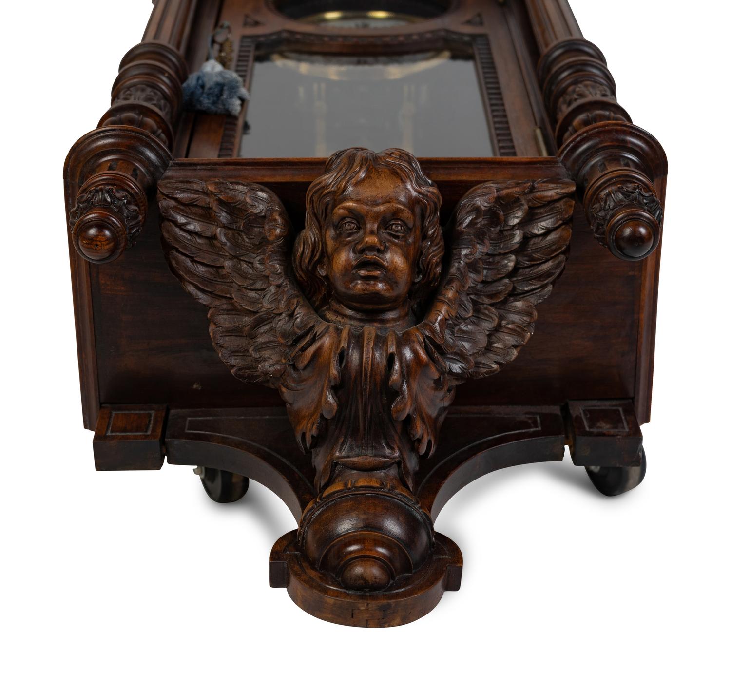 A Renaissance Revival Carved Walnut Regulator Clock