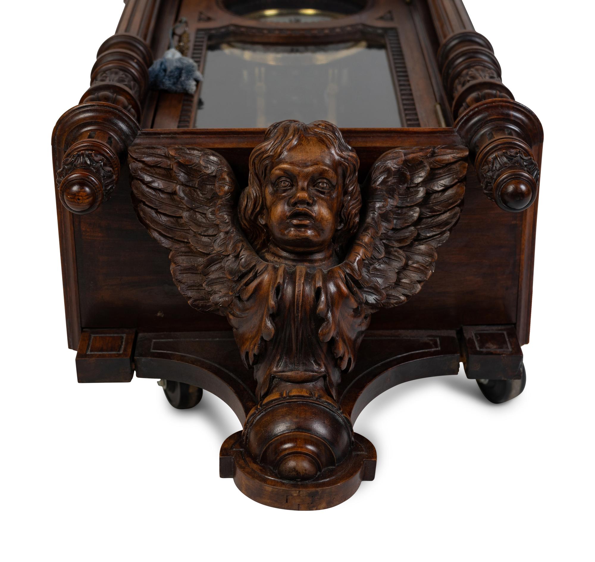 A Renaissance Revival Carved Walnut Regulator Clock