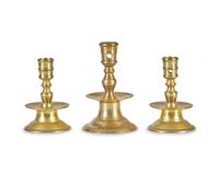 A Group of Three Dutch Brass Candlesticks