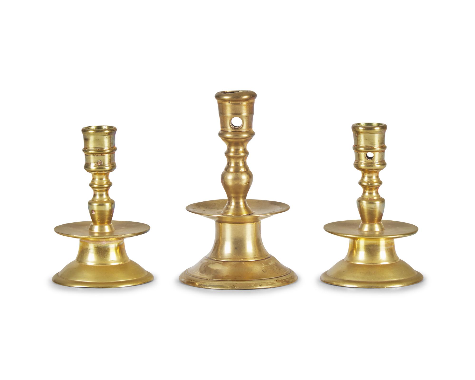 A Group of Three Dutch Brass Candlesticks