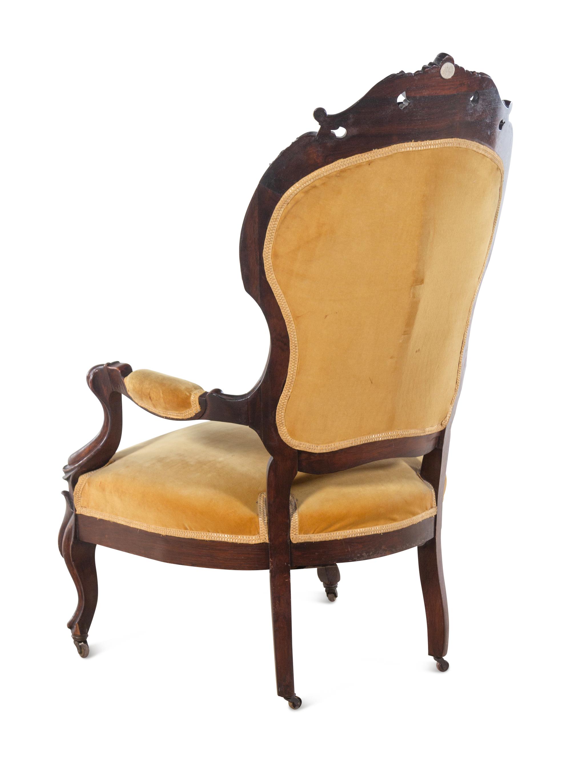 A Victorian Rococo Revival Carved Walnut Armchair