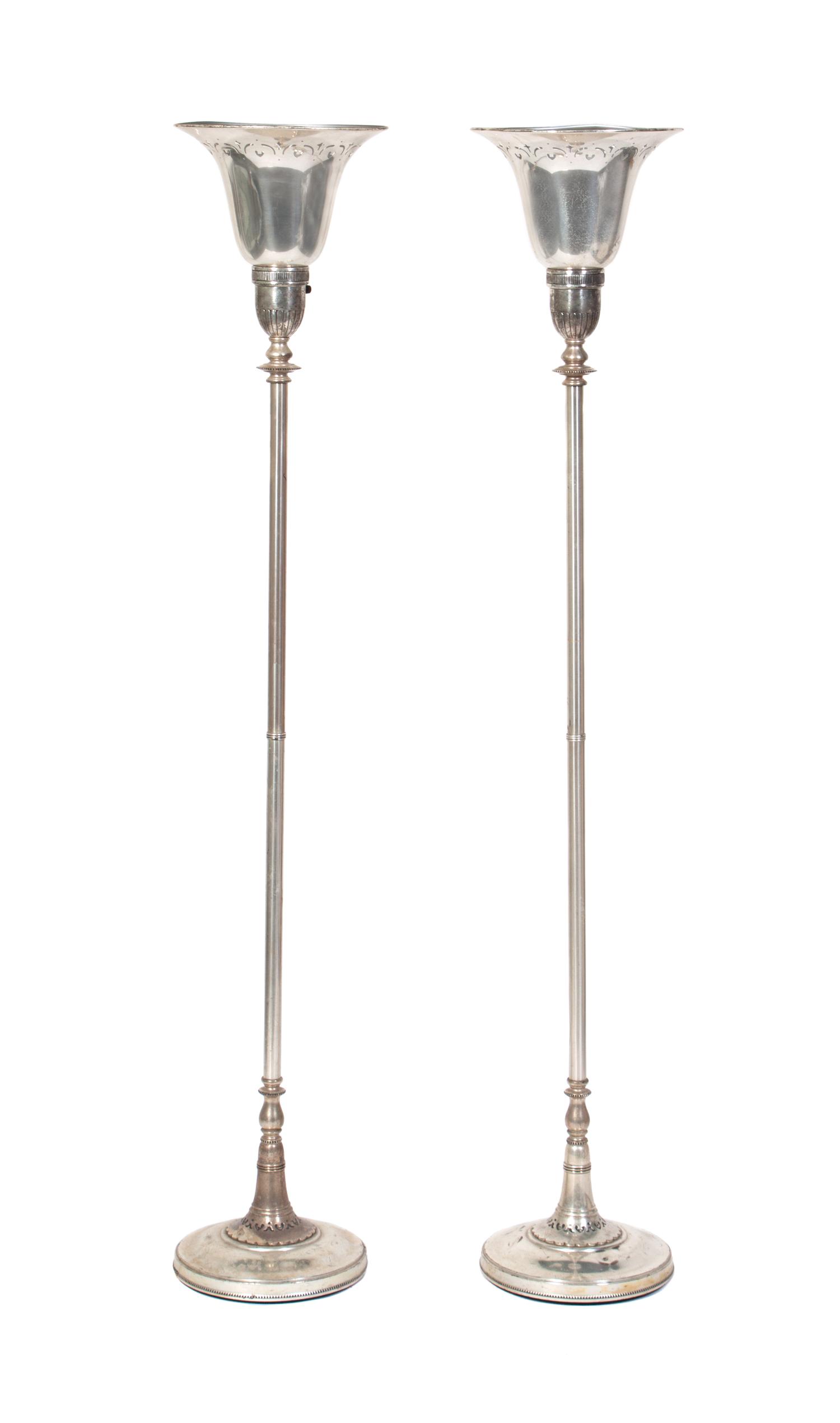 A Pair of Silver Torcheres Height 67 inches.
